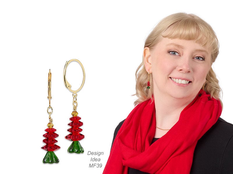 Model wearing christmas tree earrings