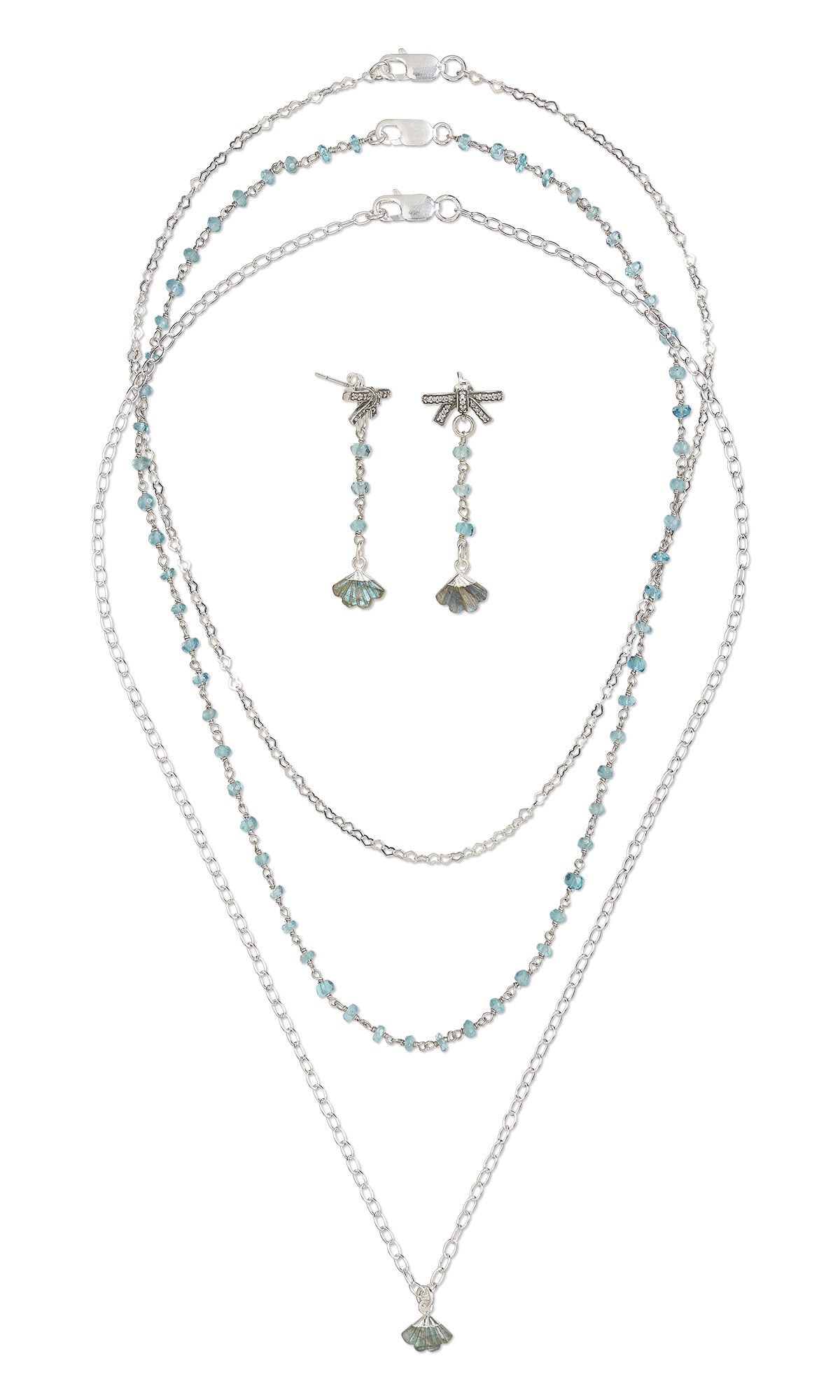 Design Idea R K 2 E - Three delicate silver necklaces, one with tiny aqua gemstones about every half inch. The longest necklace has a rough grey gemstone and silver drop. The earrings feature an inch of aqua gemstone-studded chain with a rough grey gemstone and silver drop at the bottom.
