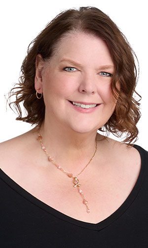 model in a black top wearing Design Idea R G 2 B Single-strand necklace featuring round moonstone gemstone beads paired with faceted Crystal Passions® crystal beads, accented with delicate chain links.