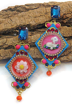 Earrings displayed on a piece of driftwood