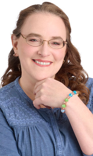 Design Idea R F 2 7 on a smiling woman with glasses