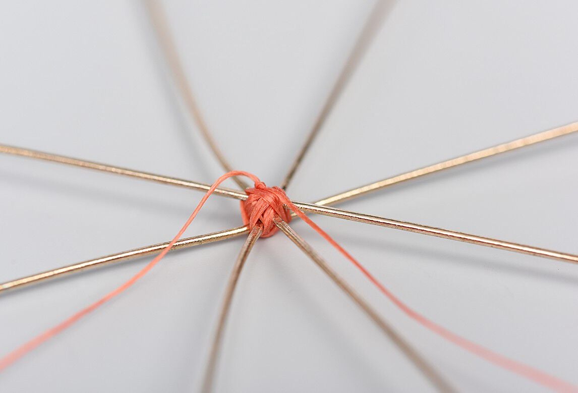 Metal ornament frame showing thread-wrapping pattern for Step 2