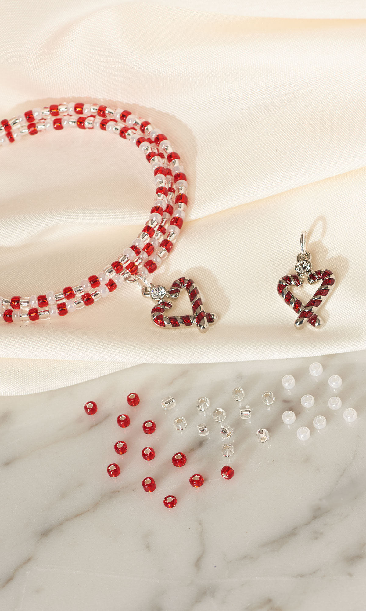 Design Idea R E 2 A laying on a white cloth with beads and charms