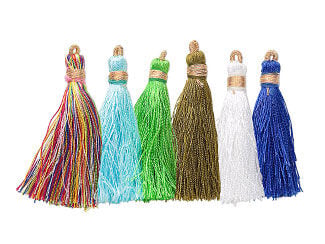 Six silk tassels tied with gold-hued tread. The colors are, from left to right, multicolored, light blue, green, brown, white and blue.