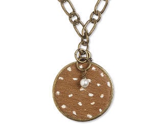 Design Idea S G 2 9 - Closeup of a tan and white polymer clay pendant made to look like deer fur. A pearl drop hangs in front of it.