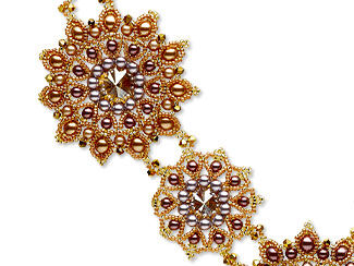 Design Idea C 2 3 U - Closeup of gold-hued seed-beaded round or star-like shapes that are part of a larger necklace