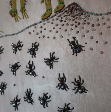 Beaded ants on cloth