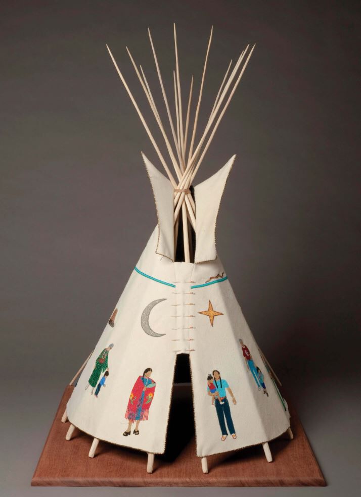A small beaded tipi with figures on it