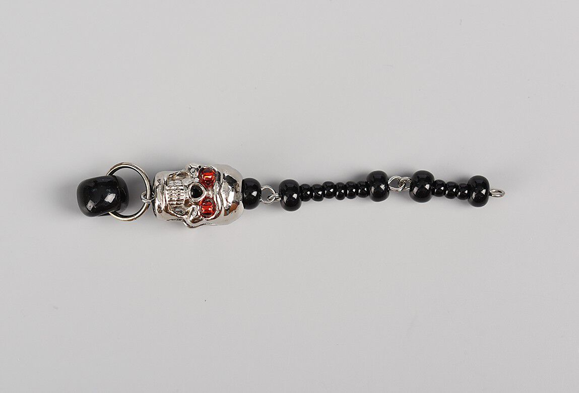 Dangle showing black seed beads and skull bead