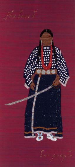 A beaded figure holding a sword