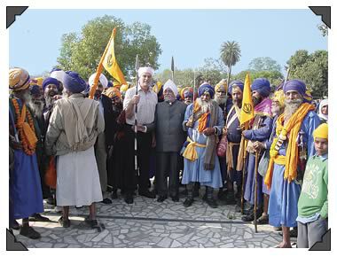 Stuart (in white shirt) with Sukhdev's father, Joginder Singh Nagi, and Sikh warriors.