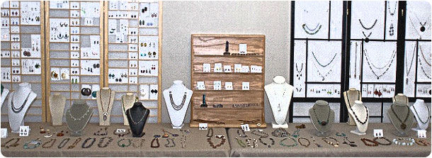 Jewelry displayed on tables, busts, and racks