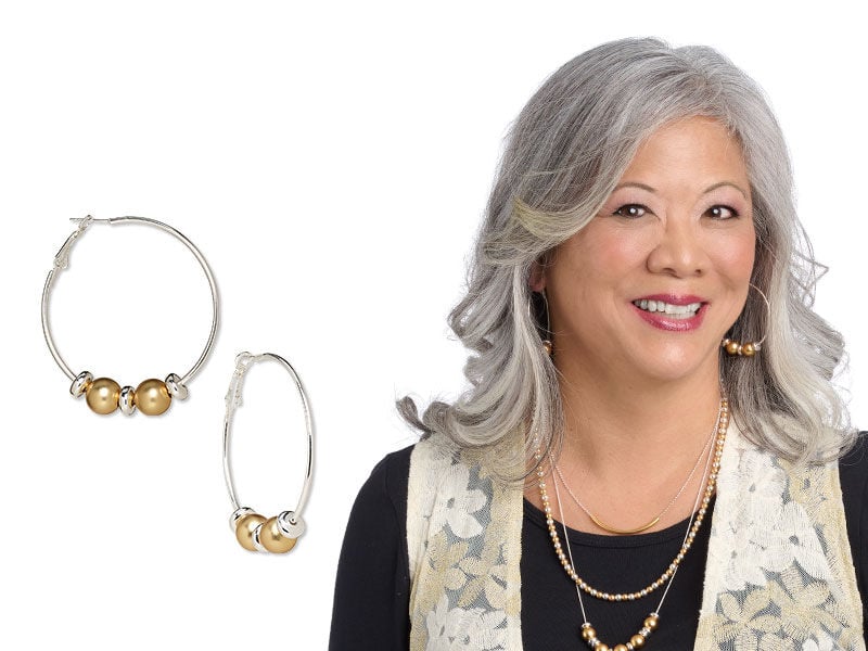 Model wearing earrings made with metal beads