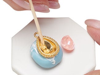 Epoxy is being applied to the empty teardrop setting