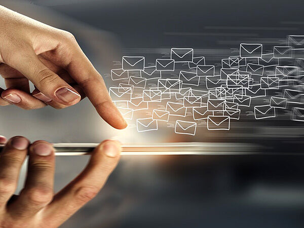 Hands holding a phone sending mail