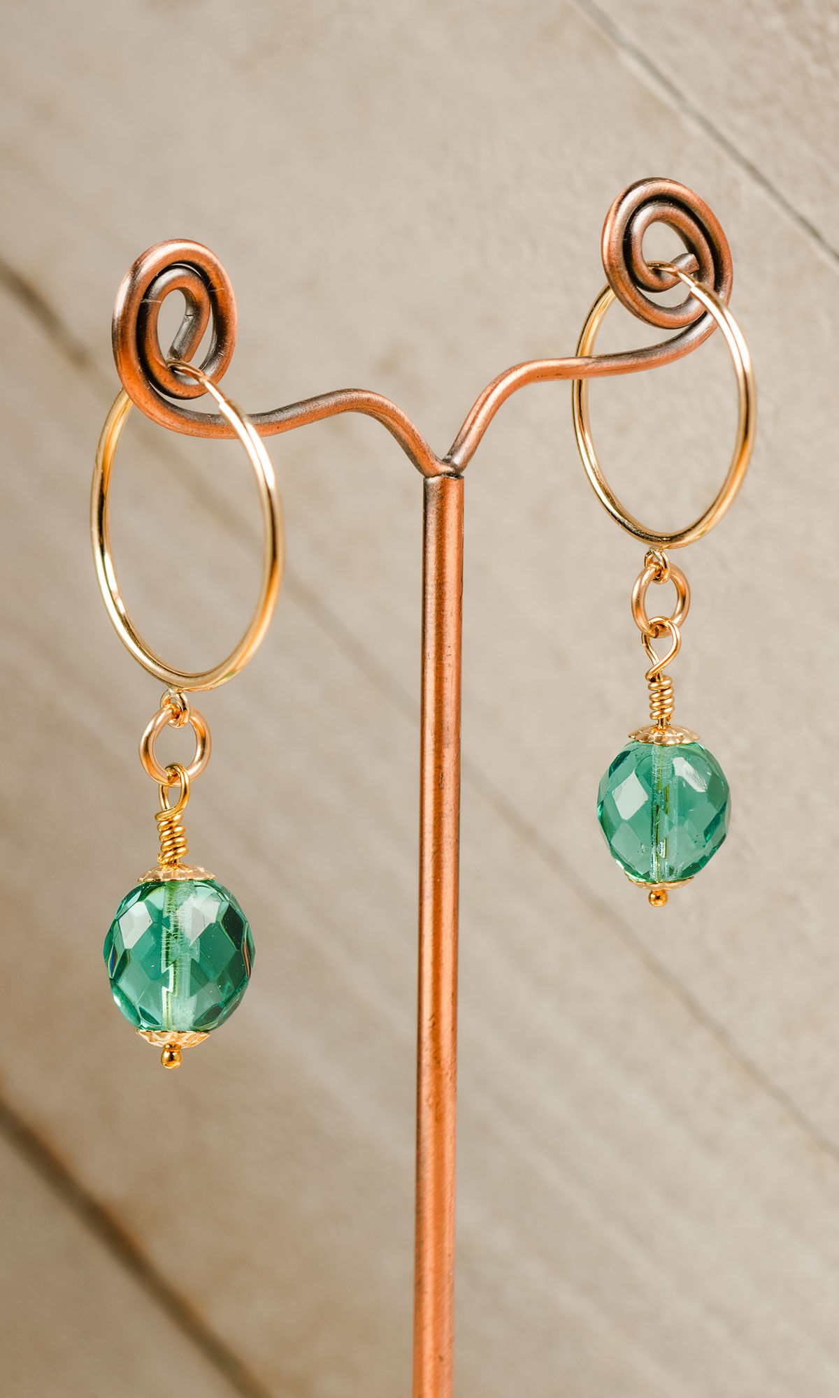 Sparkling earrings hanging from wire display tree