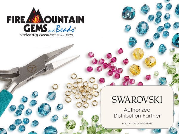 Scattered blue, brown, magenta and yellow crystal beads with a pile of golden jump rings near the center of the image. Pliers with blue handles are on the left and a text box with the words "Swarovski Authorized Distribution Partner for crystal components" on the lower right.