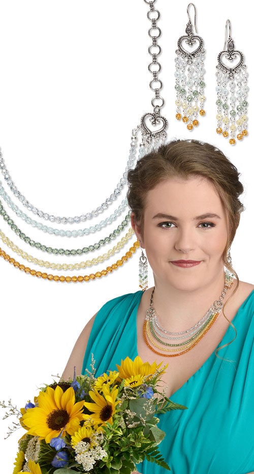 Model wearing multi strand necklace made with crystal passions beads and earrings