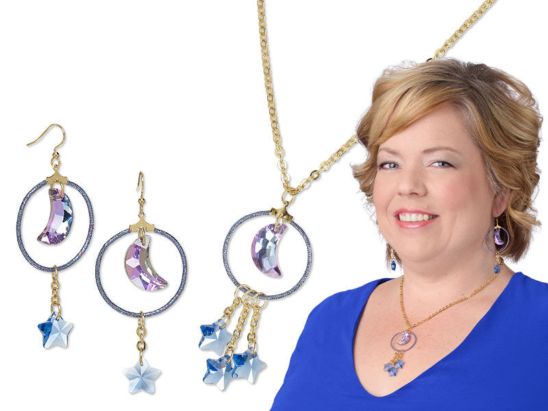 Model in blue wearing moon and star necklace and earrings
