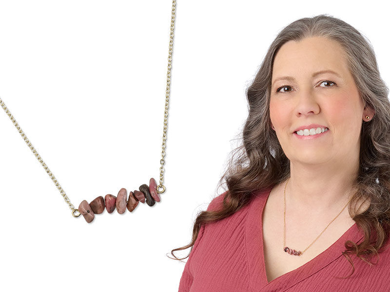 Model wearing a necklace with gemstones