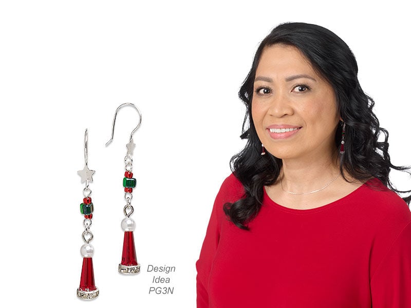 Model wearing earrings that are christmas themed