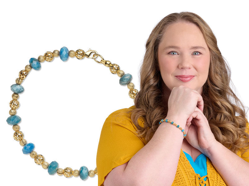 Model wearing a bracelet made with metal beads and gemstones