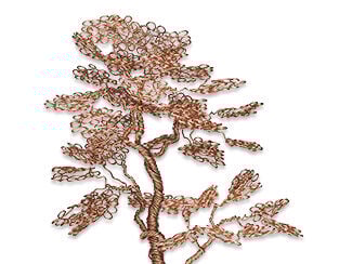 Copper wire tree includes coils of wire creating roots, trunk, branches and leaves.