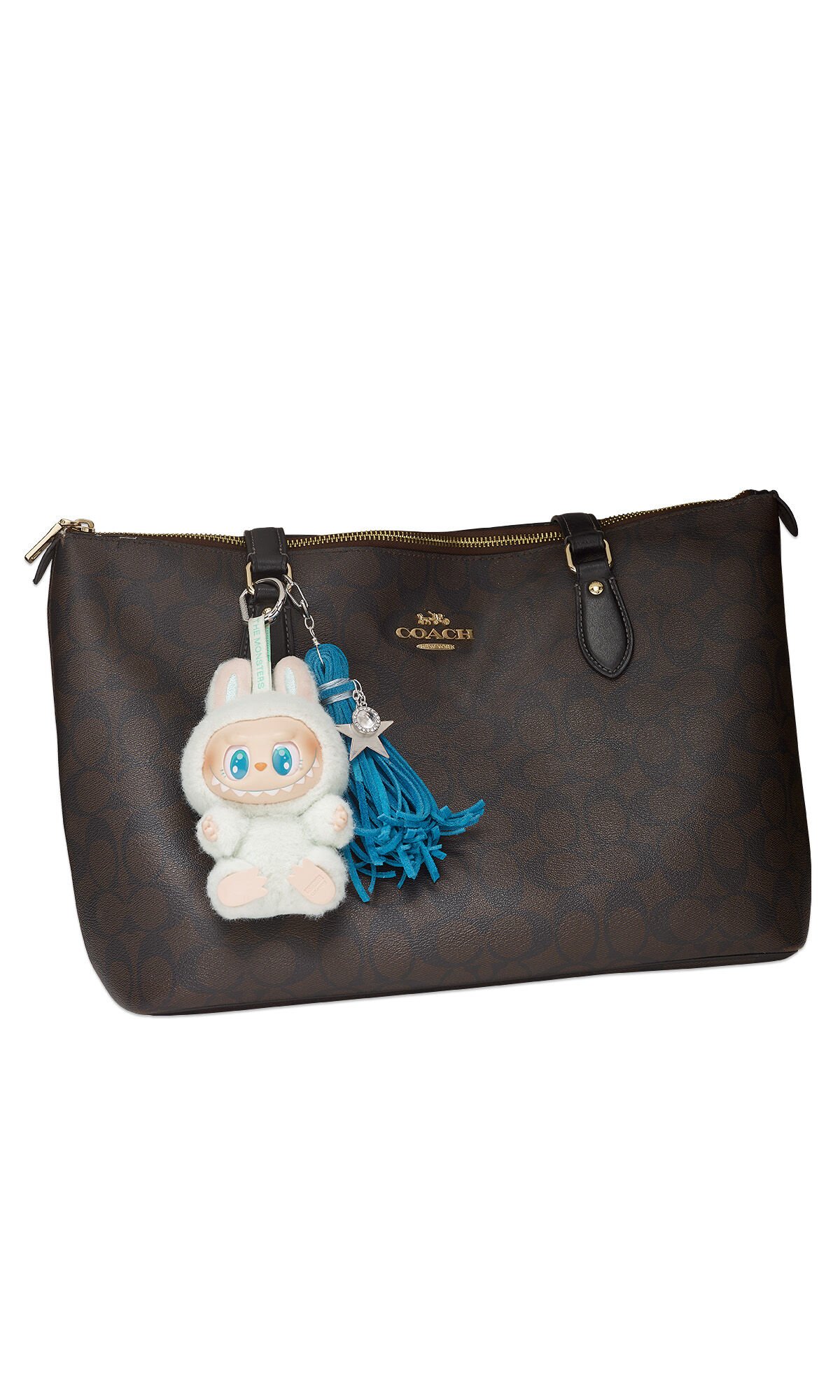 Purse with tassel and Labubu charms hanging on the side