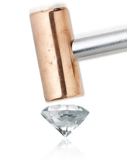 Hammer hitting a clear diamond
