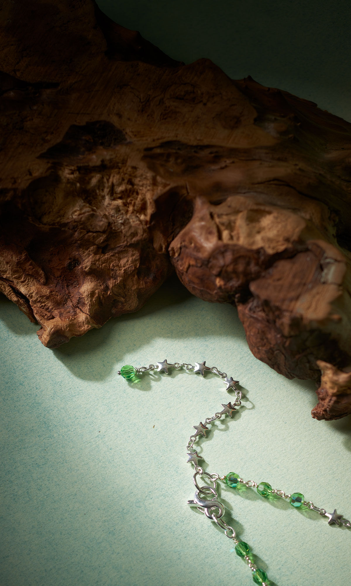 Design Idea QG39 necklace back next to a stump