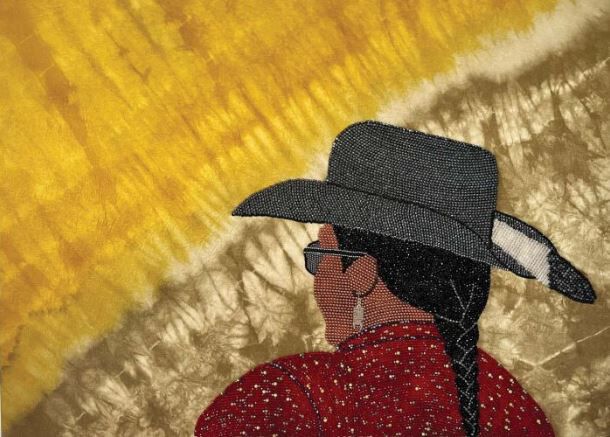 a beaded woman wearing a hat and sunglasses