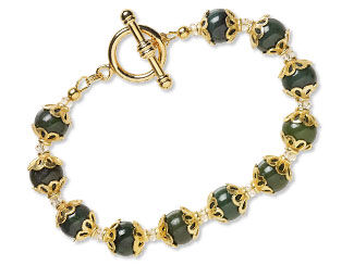 An image of a beaded bracelet that is using nephrite jade beads and gold bead caps