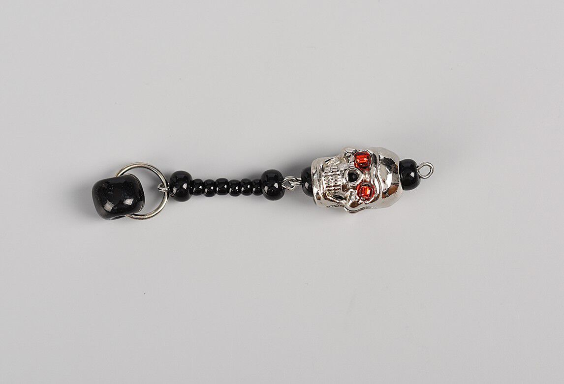 Shorter dangle showing black seed beads and skull bead