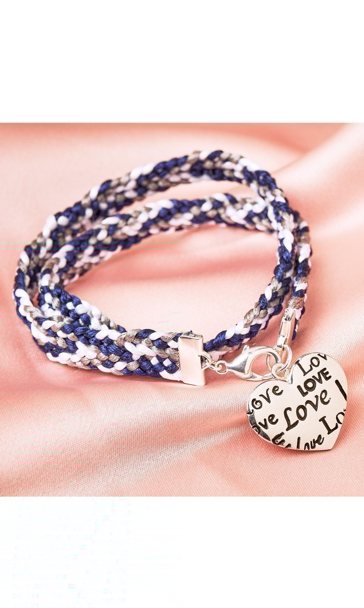 Design Idea R C 3 K 10-Strand flat braided bracelet with white, silver, and blue cord on peach satin fabric