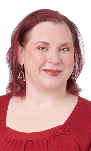 Design Idea Q H 2 V - A smiling woman wearing festive candy cane drop earrings accented with small green bows.