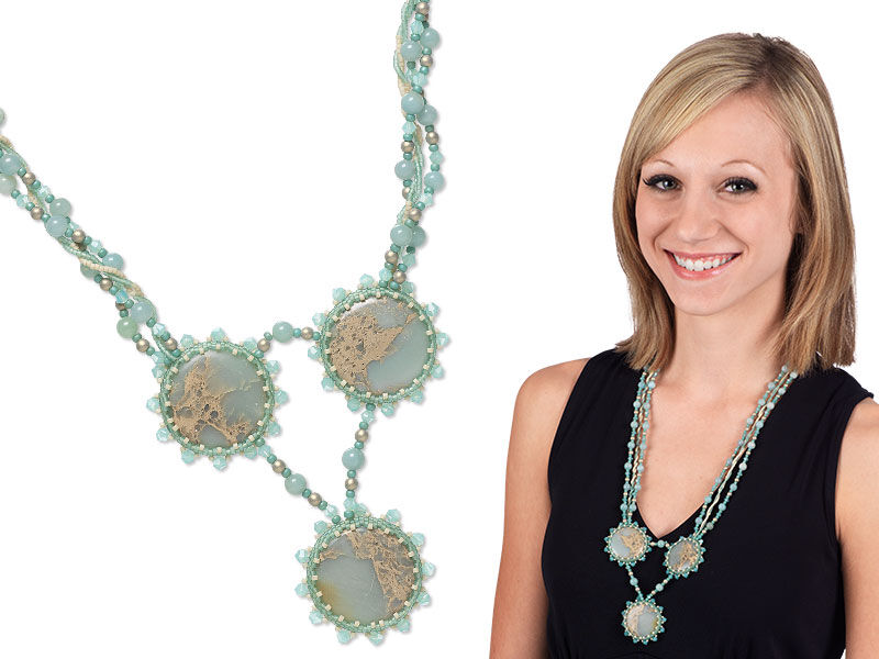 Model wearing a necklace and earrings with seed beads