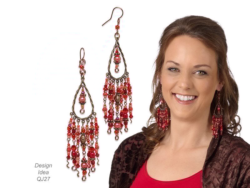 Model in blue wearing crystal dangled earrings