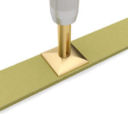 Rhinestud on metal strip being pressed with applicator