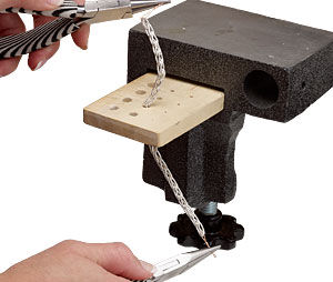 Chain being pulled through a draw plate