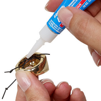 Adhesive being added to the knot