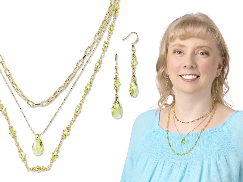 Model wearing layered chain necklaces