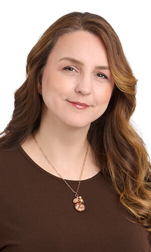 Model wearing brown blouse modeling necklace