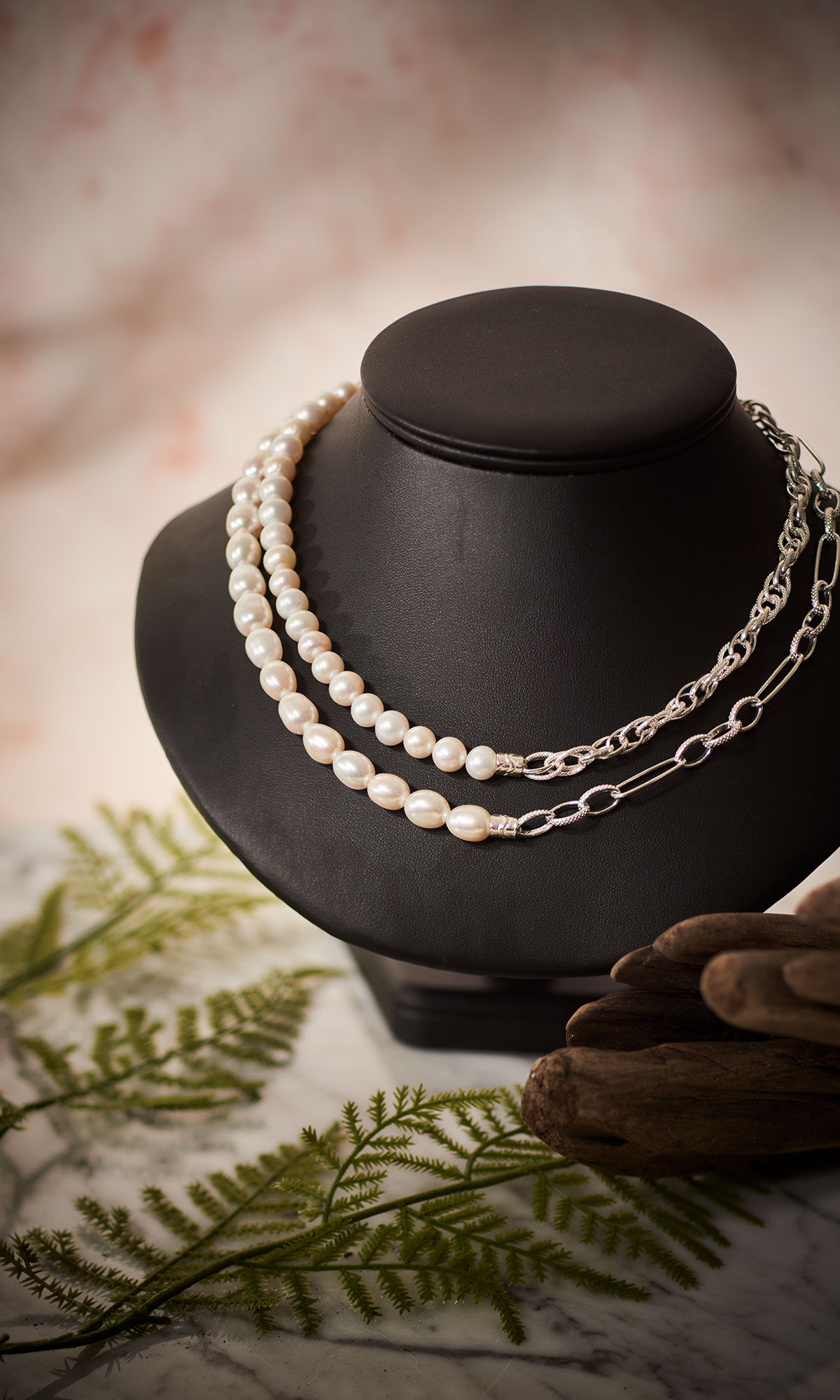 Design Idea Q J 6 A on a black necklace display