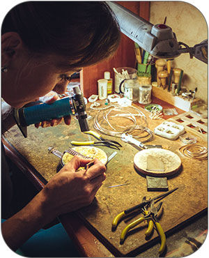 Woman torching a jewelry piece