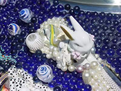 Rabbit figurine among beads
