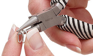 Jump ring being bent around pliers