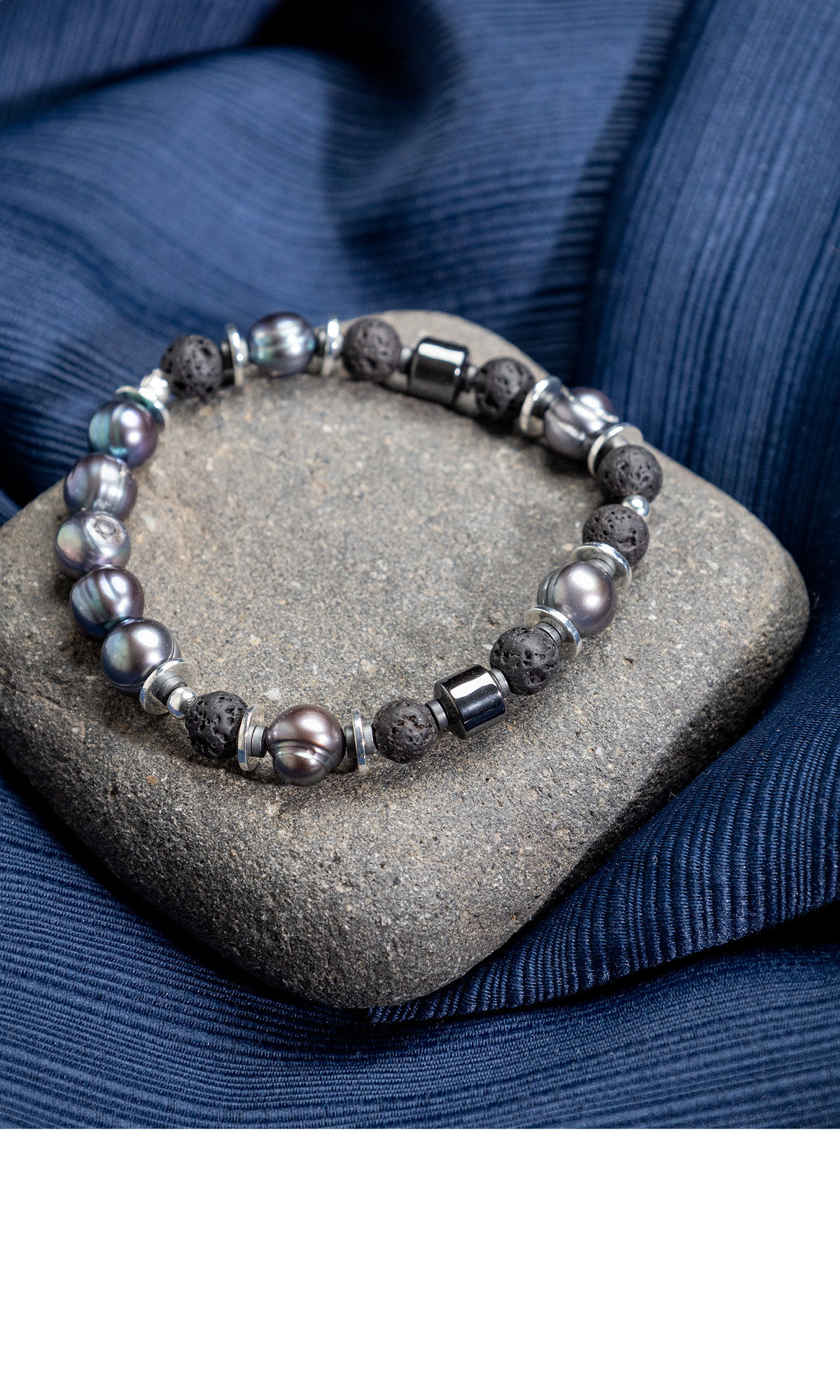Design Idea QM3A on a rock surrounded by navy blue cloth