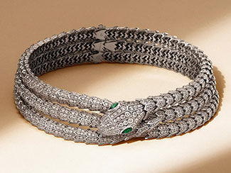 Triple-strand silver bracelet. The end of the bracelet is a snake head.