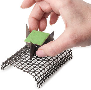 Metal square being placed on trivet