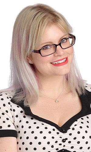 A smiling woman wearing Design Idea K 3 1 F